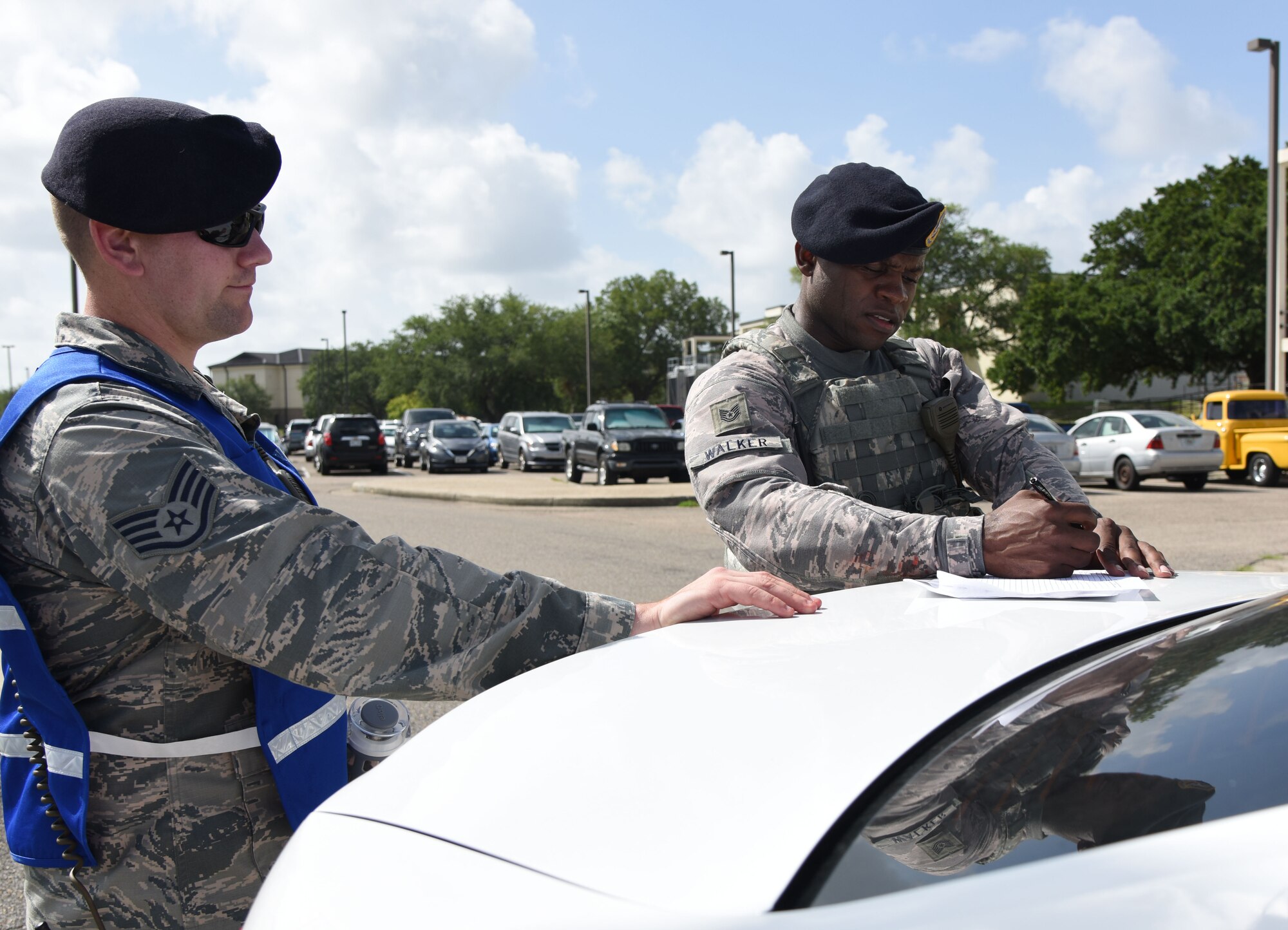 U.S. Air Force Staff Sgt. Matthew Clinesmith, 81st Security Forces Squadron wing inspection team member, inspects Tech. Sgt. Marvin Walker, 81st SFS flight chief, as he plots the evacuated buildings within the cordon area during a major accident response exercise near the flight line at Keesler Air Force Base, Mississippi, June 21, 2018. The exercise scenario simulated a C-130J Super Hercules in-flight emergency causing a plane crash, which resulted in a mass casualty response event. This exercise tested the base’s ability to respond in a crisis situation. (U.S. Air Force photo by Kemberly Groue)