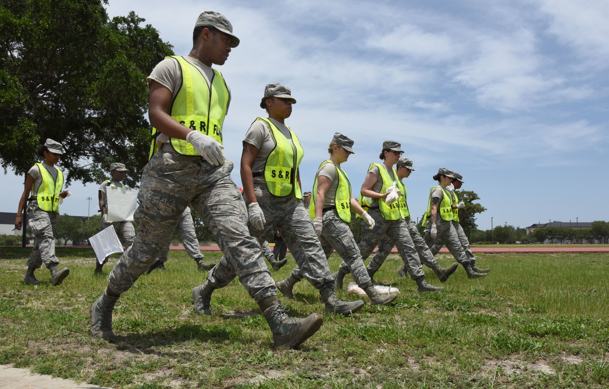 Members of the 81st Force Support Squadron Search and Recovery Team conduct a sweep of the scene during a major accident response exercise near the triangle track at Keesler Air Force Base, Mississippi, June 21, 2018. The exercise scenario simulated a C-130J Super Hercules in-flight emergency causing a plane crash, which resulted in a mass casualty response event. This exercise tested the base’s ability to respond in a crisis situation. (U.S. Air Force photo by Kemberly Groue)