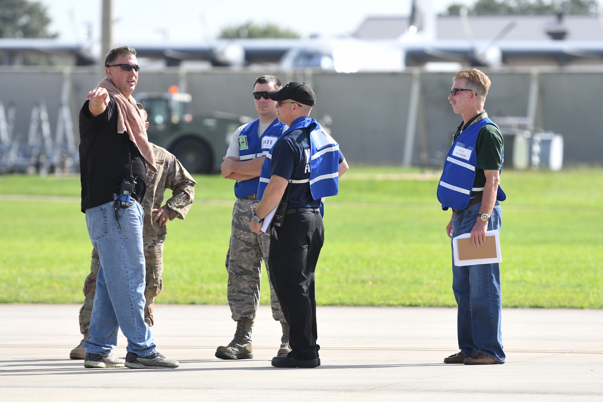 Members of the 81st Training Wing wing inspection team discuss the scenario during a major accident response exercise on the flight line at Keesler Air Force Base, Mississippi, June 21, 2018. The exercise scenario simulated a C-130J Super Hercules in-flight emergency causing a plane crash, which resulted in a mass casualty response event. This exercise tested the base’s ability to respond in a crisis situation. (U.S. Air Force photo by Kemberly Groue)