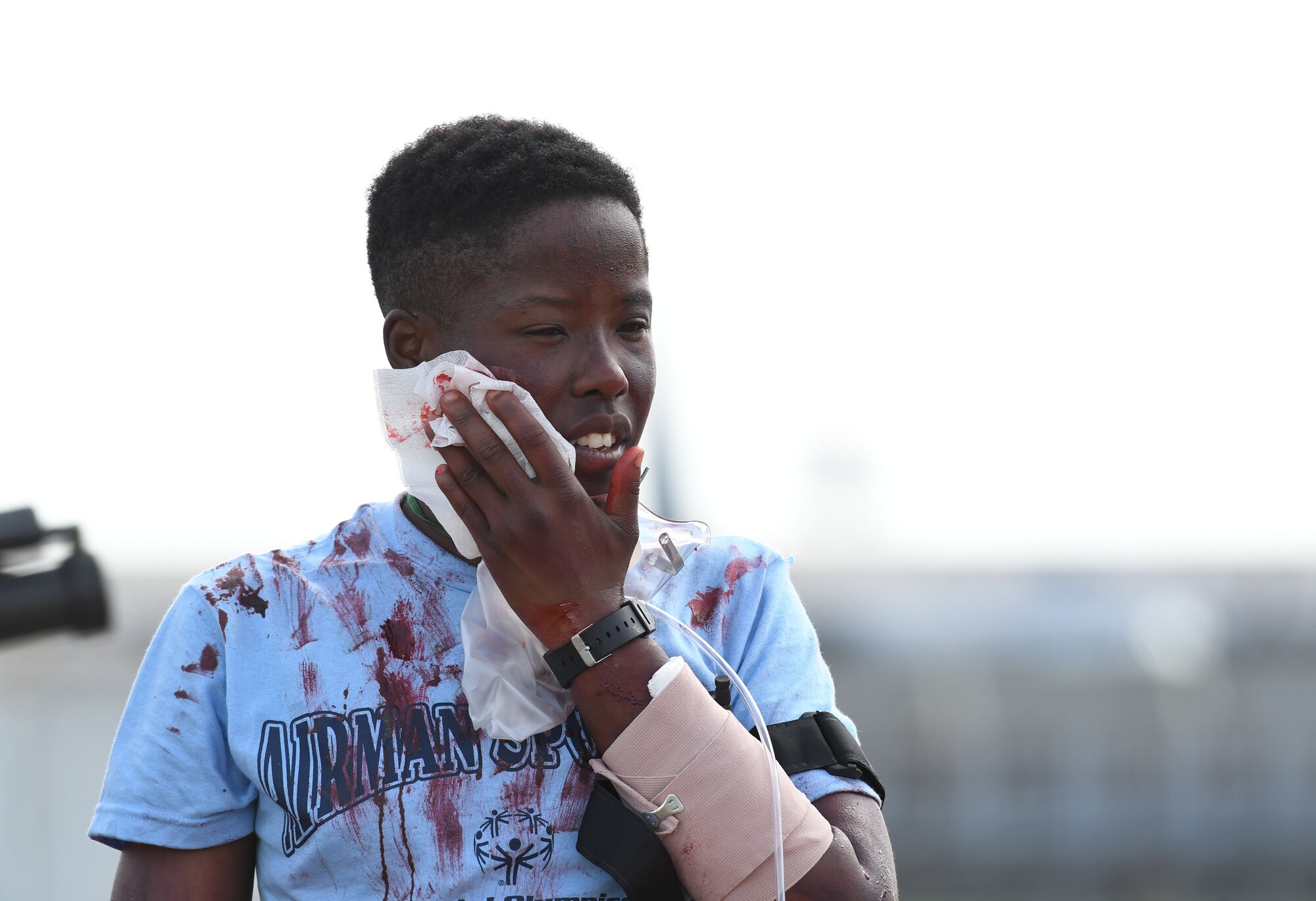 U.S. Air Force Airman 1st Class Kellie Oglesby, 336th Training Squadron student, portrays a “victim” as she holds a cloth to her face during a major accident response exercise on the flight line at Keesler Air Force Base, Mississippi, June 21, 2018. The exercise scenario simulated a C-130J Super Hercules in-flight emergency causing a plane crash, which resulted in a mass casualty response event. This exercise tested the base’s ability to respond in a crisis situation. (U.S. Air Force photo by Kemberly Groue)