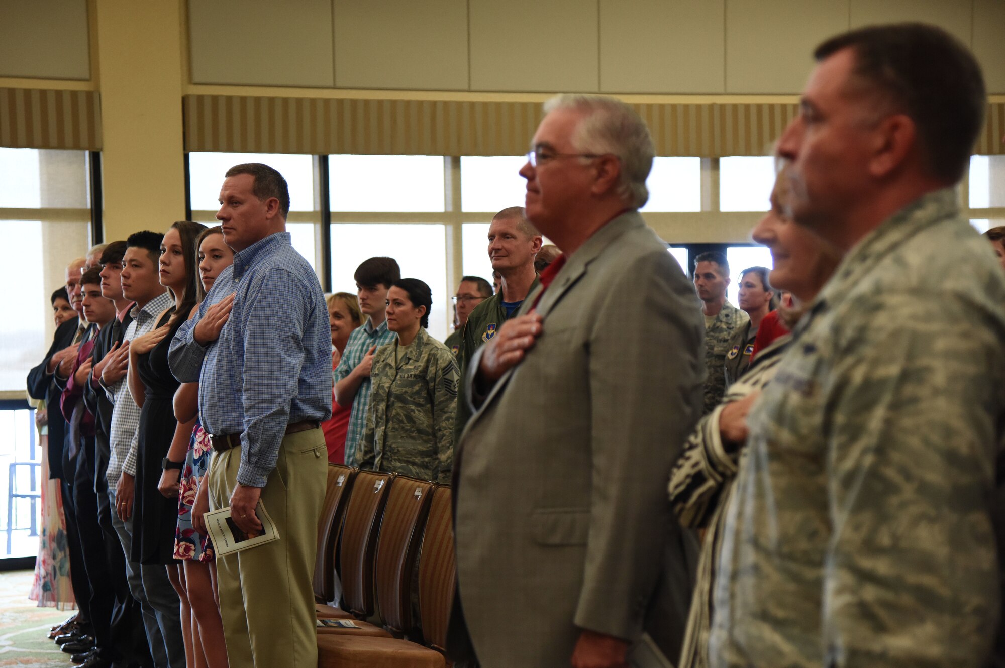 Keesler personnel, families and friends attend the 81st Medical Group change of command ceremony in the Bay Breeze Event Center at Keesler Air Force Base, Mississippi, June 22, 2018. U.S. Air Force Col. Beatrice Dolihite, incoming 81st MDG commander, assumed command from Col. Jeannine Ryder, outgoing 81st MDG commander, with the passing of the guidon. (U.S. Air Force photo by Kemberly Groue)