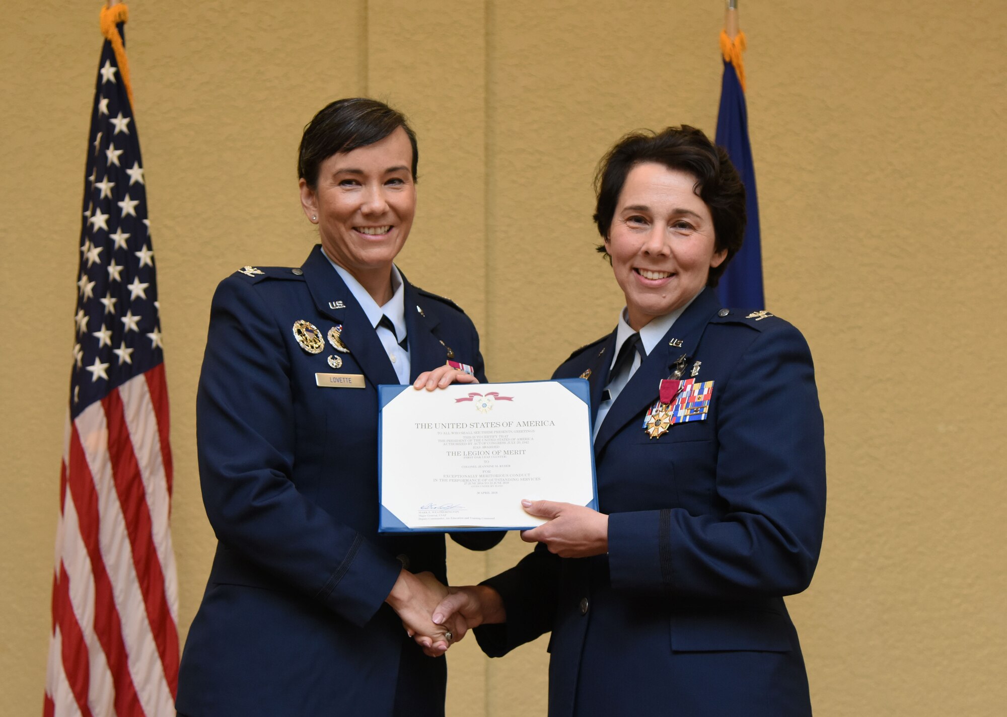 U.S. Air Force Col. Debra Lovette, 81st Training Wing commander, presents Col. Jeannine Ryder, outgoing 81st Medical Group commander, with a Legion of Merit first oak leaf cluster certificate during the 81st MDG change of command ceremony in the Bay Breeze Event Center at Keesler Air Force Base, Mississippi, June 22, 2018. Ryder relinquished command of the 81st MDG and will be heading to the Air Force Material Command, Wright-Patterson Air Force Base, Ohio, where she will be the surgeon general. (U.S. Air Force photo by Kemberly Groue)