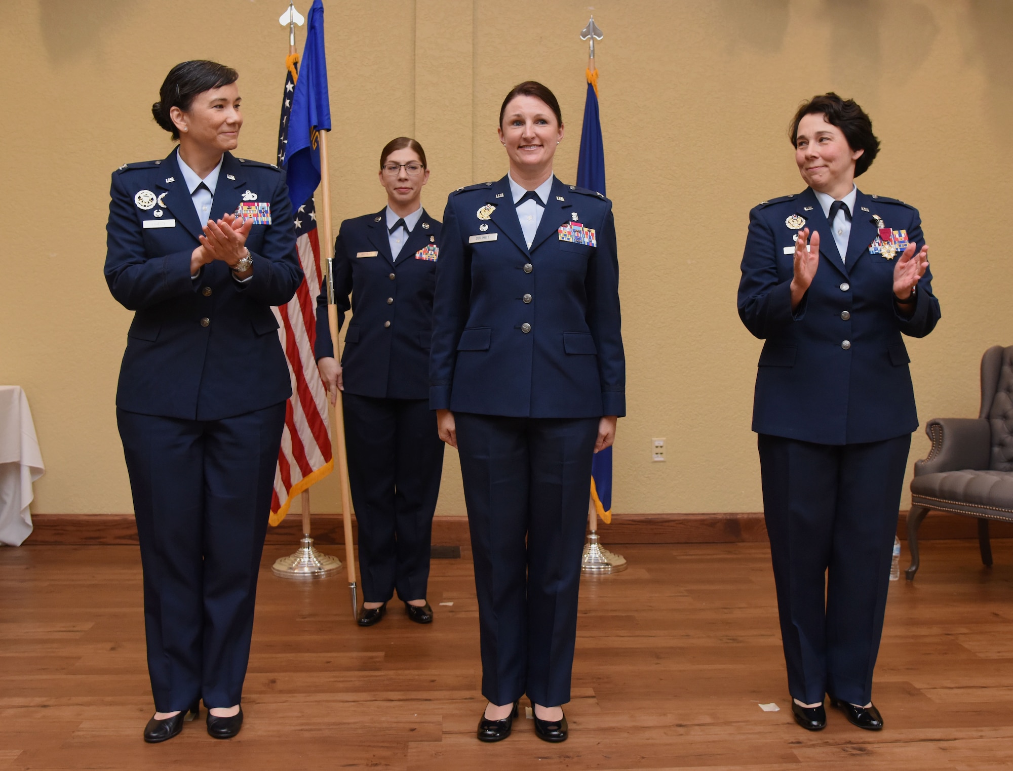 U.S. Air Force Col. Debra Lovette, 81st Training Wing commander, and Col. Jeannine Ryder, outgoing 81st Medical Group commander, congratulate Col. Beatrice Dolihite, incoming 81st MDG commander, during the 81st MDG change of command ceremony in the Bay Breeze Event Center at Keesler Air Force Base, Mississippi, June 22, 2018. The passing of the guidon is a ceremonial symbol of exchanging command from one commander to another. (U.S. Air Force photo by Kemberly Groue)