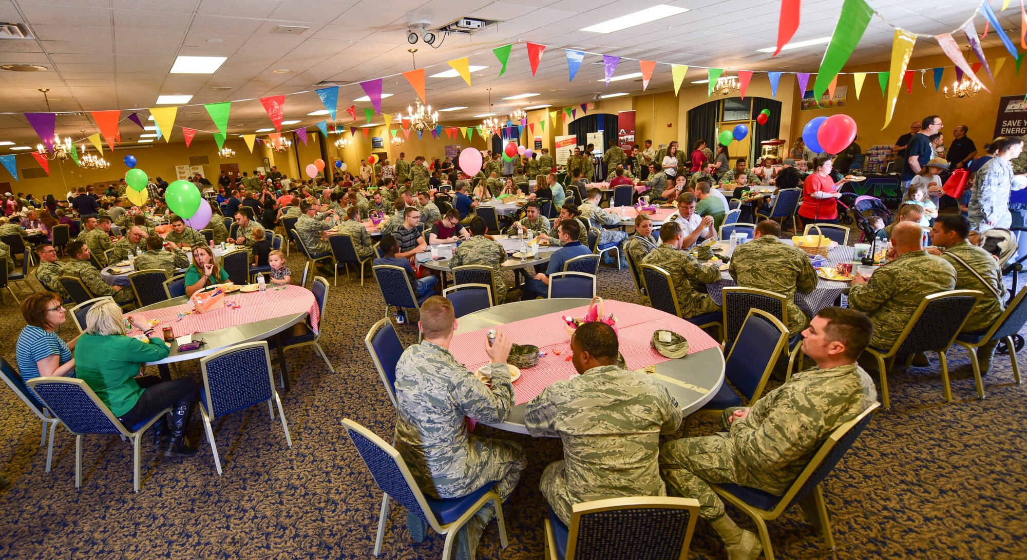 Ellsworth Airmen and their families eat and socialize during the annual base picnic inside the Dakota’s Club at Ellsworth Air Force Base, S.D., June 22, 2018. The picnic provided Airmen the opportunity to take a break from work while enjoying a free lunch and various activities. (U.S. Air Force photo by Senior Airman Randahl J. Jenson)