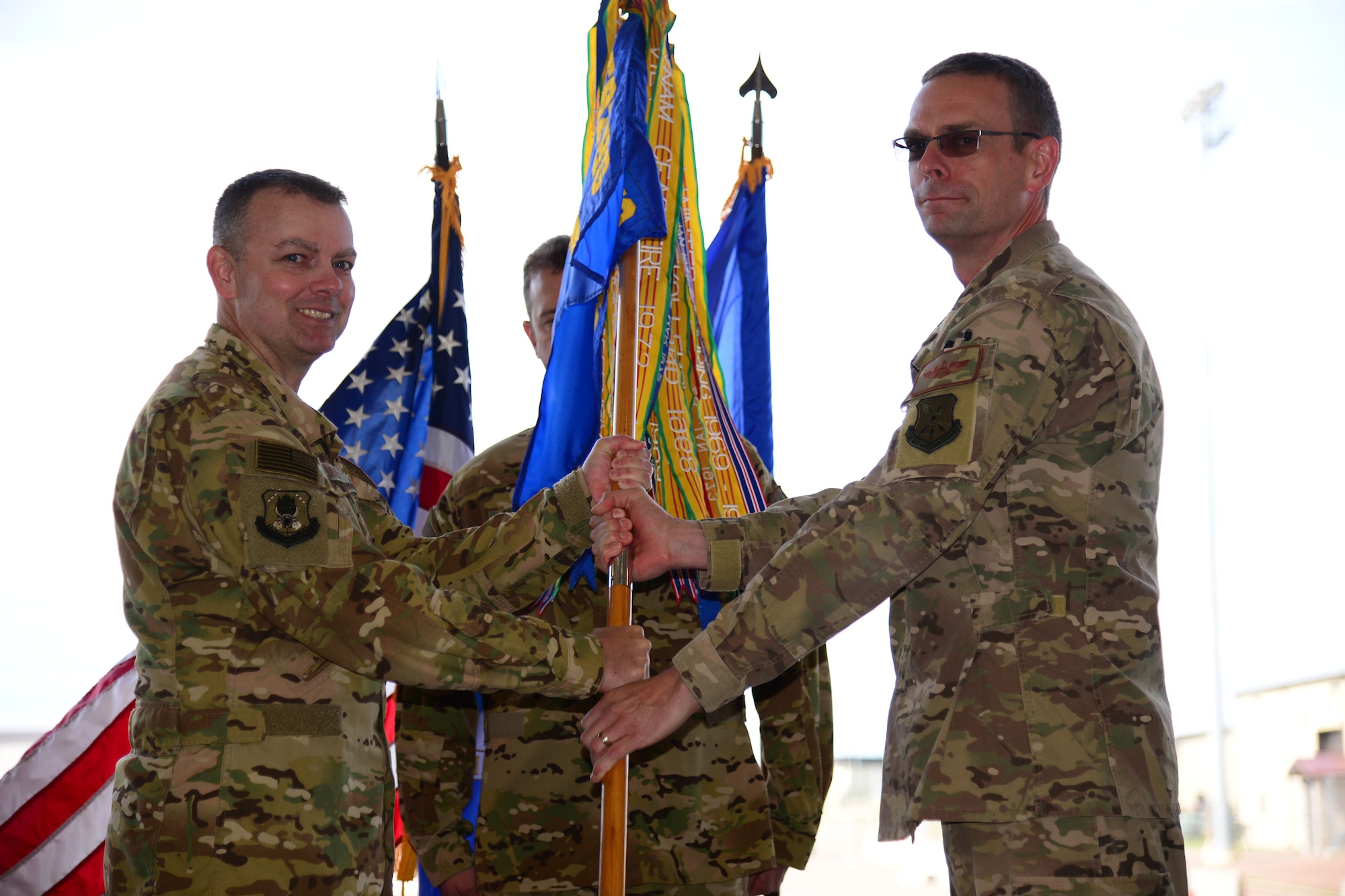 Lt. Col. Bryan Tuinman, right, accepts command of the 40th Helicopter Squadron from Col. Joshua Bowman, 582nd Helicopter Group commander, during an assumption of command ceremony June 22, 2018, at Malmstrom AFB, Mont.