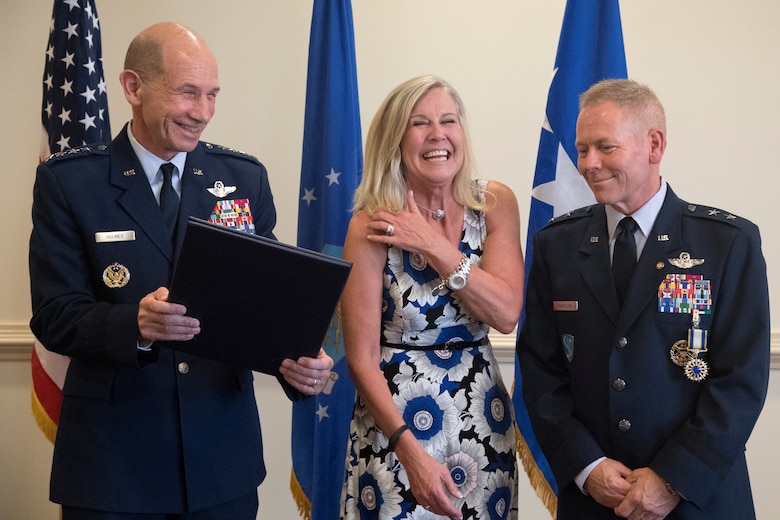 Photo of Gen. Mike Holmes, the commander of Air Combat Command, and Kim McMullen during the retirement ceremony of her husband, Maj. Gen. John K. McMullen