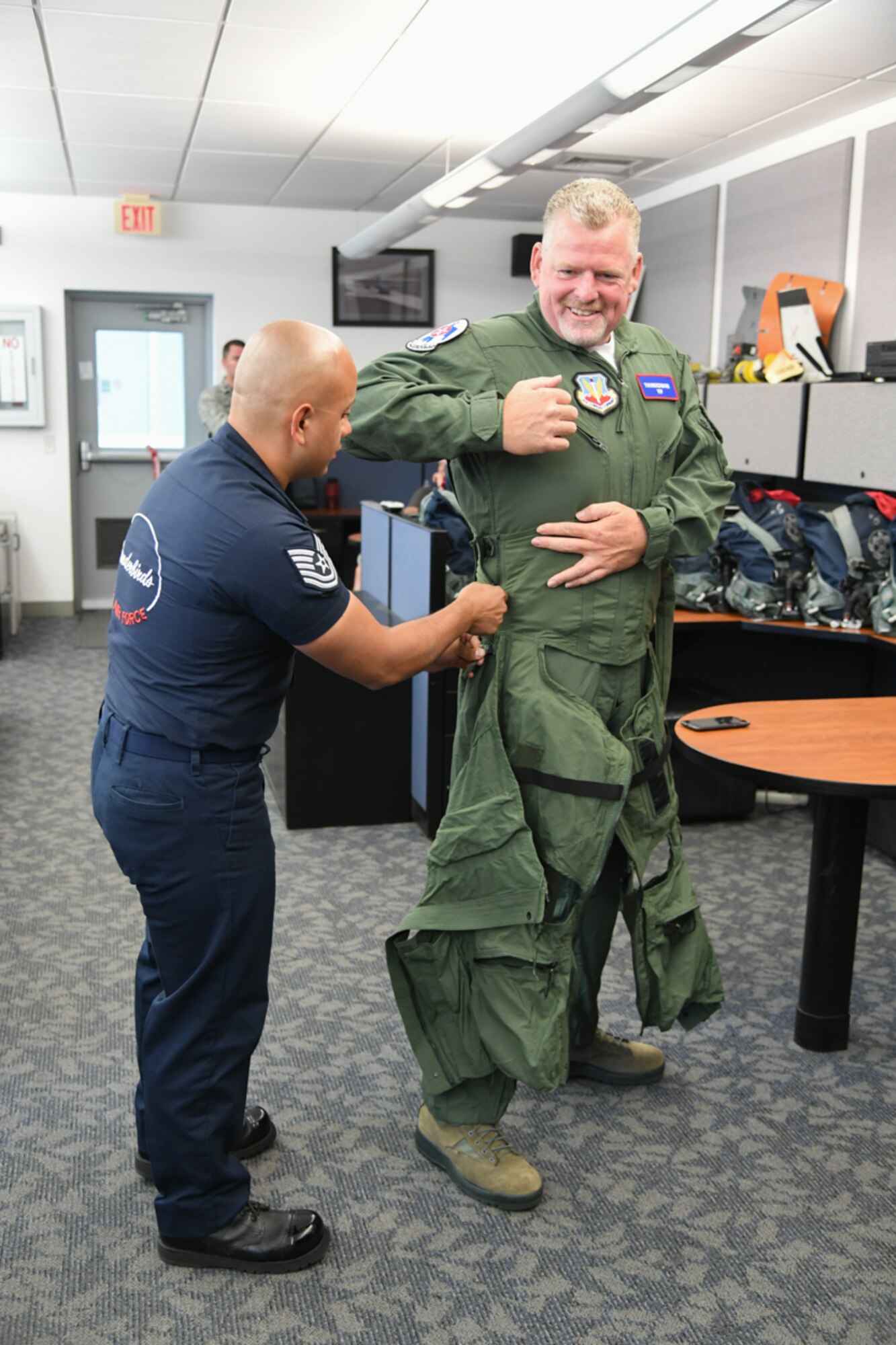 Sergeant Aaron Thompson, Utah Washington County Sheriff, gets fitted for his anti-g suit with the help of  Tech. Sgt. Ed Portan, U.S. Air Force Thunderbirds aircrew flight equipment, June 22, 2018, at Hill Air Force Base, Utah. Thompson was selected to fly with the Thunderbirds as part of their Hometown Hero program. (U.S. Air Force photo by Cynthia Griggs)