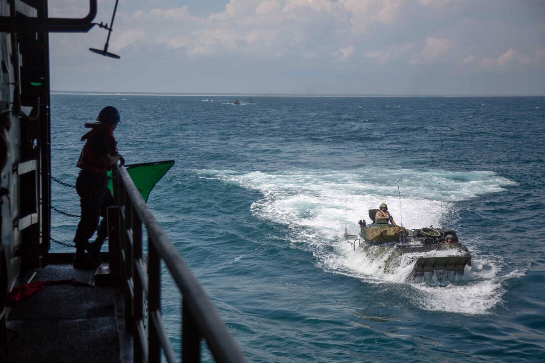 U.S. Marine AAV-P7/A1 Assault Amphibian Vehicles with the 22nd Marine Expeditionary Unit board the USS Arlington via the well deck during Amphibious Squadron-MEU Integration training in the Atlantic Ocean, June 15, 2018. PHIBRON-MEU Integration is a two-week training evolution that allows Sailors and U.S. Marines to train as a cohesive unit in preparation for their upcoming deployment.