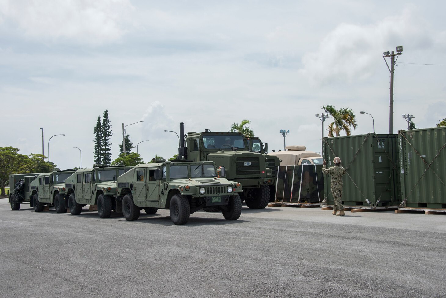 Utilitiesman 2nd Class Xiomara Fairley, from Patterson, N.J., assigned to Naval Mobile Construction Battalion (NMCB) 5, directs a vehicle during a 48-hour Mount-Out Exercise (MOX) in Okinawa, Japan June 20. The MOX simulates one of the core capabilities of a construction battalion to deploy an air detachment, along with construction equipment, within 48-hours to any required location around the globe. NMCB 5 is forward deployed to execute construction, humanitarian and foreign assistance, and theater security cooperation support of United States Pacific Command.