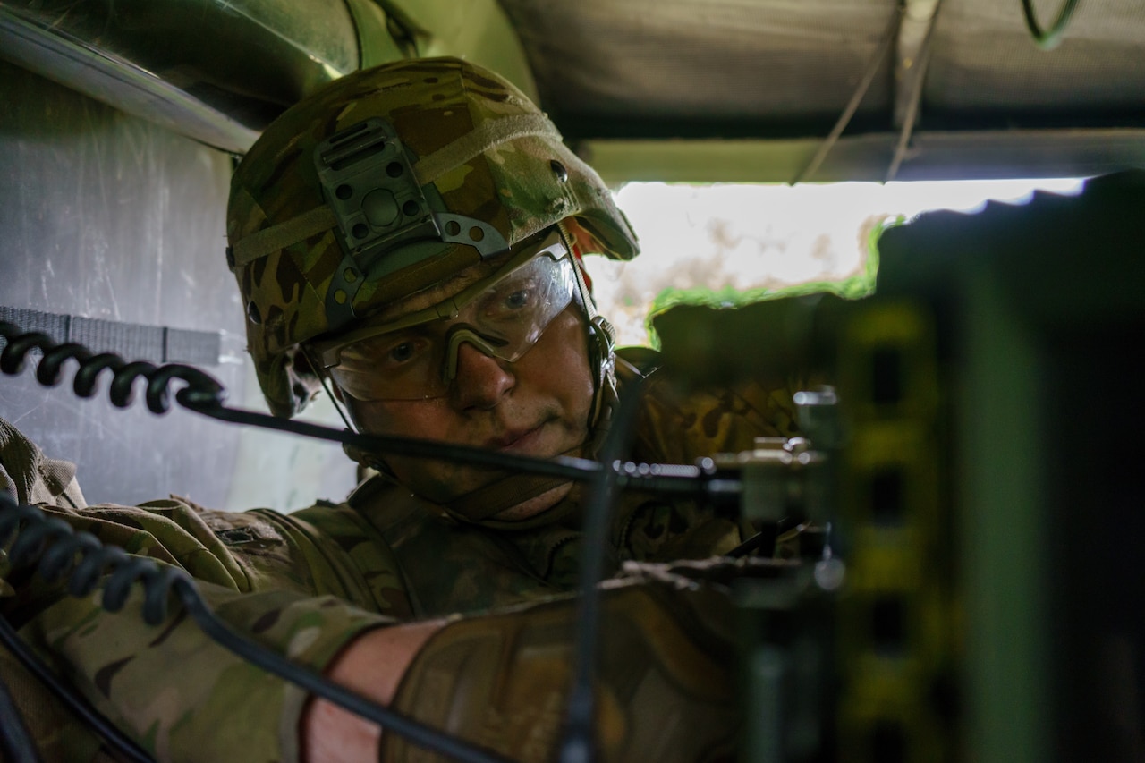 Army Spc. Lukas Natkevicius, a cavalry scout and Marijampole, Lithuania, native assigned to Headquarters and Headquarters Troop, 4th Squadron, 2d Cavalry Regiment, prepares a radio during Exercise Saber Strike 18 at a training area just outside of Kazlu Ruda, Lithuania, June 7, 2018. Army photo by Sgt. Gregory T. Summers