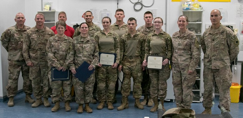 Col. Kimberly Colloton, second from right, recognizes the staff at the New Kabul Compound Medical Clinic for providing life-saving support to USACE personnel.