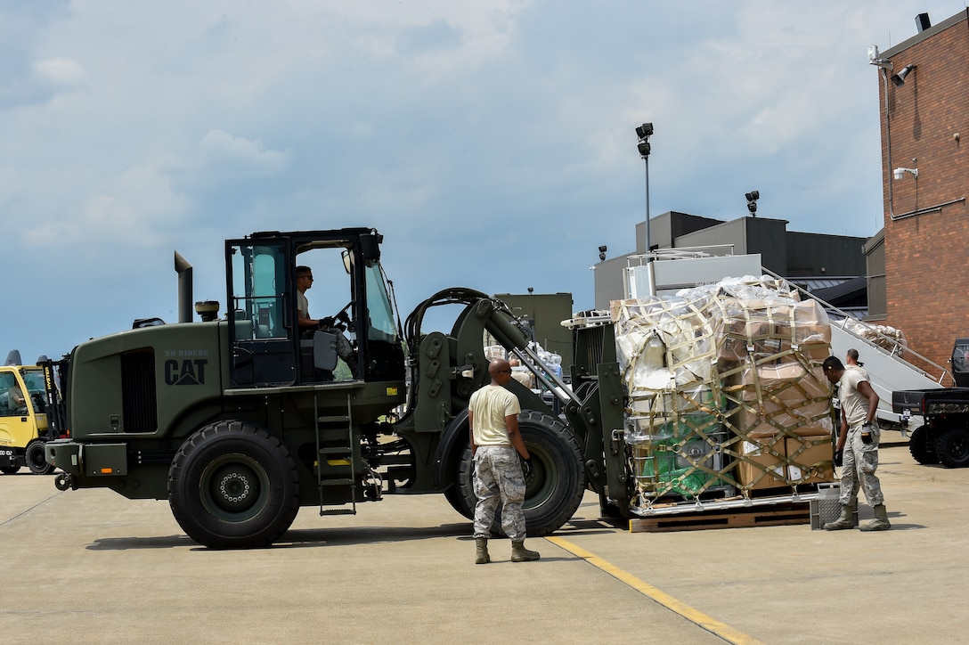 Staff Sgt. Christian Shipley operates an adverse terrain forklift while Staff Sgt. Donald Irby and Airman 1st Class Kevin Mills, all 76th Aerial Port Squadron (APS) aerial transporters, assist on the Youngstown Air Reserve Station flightline, June 3.