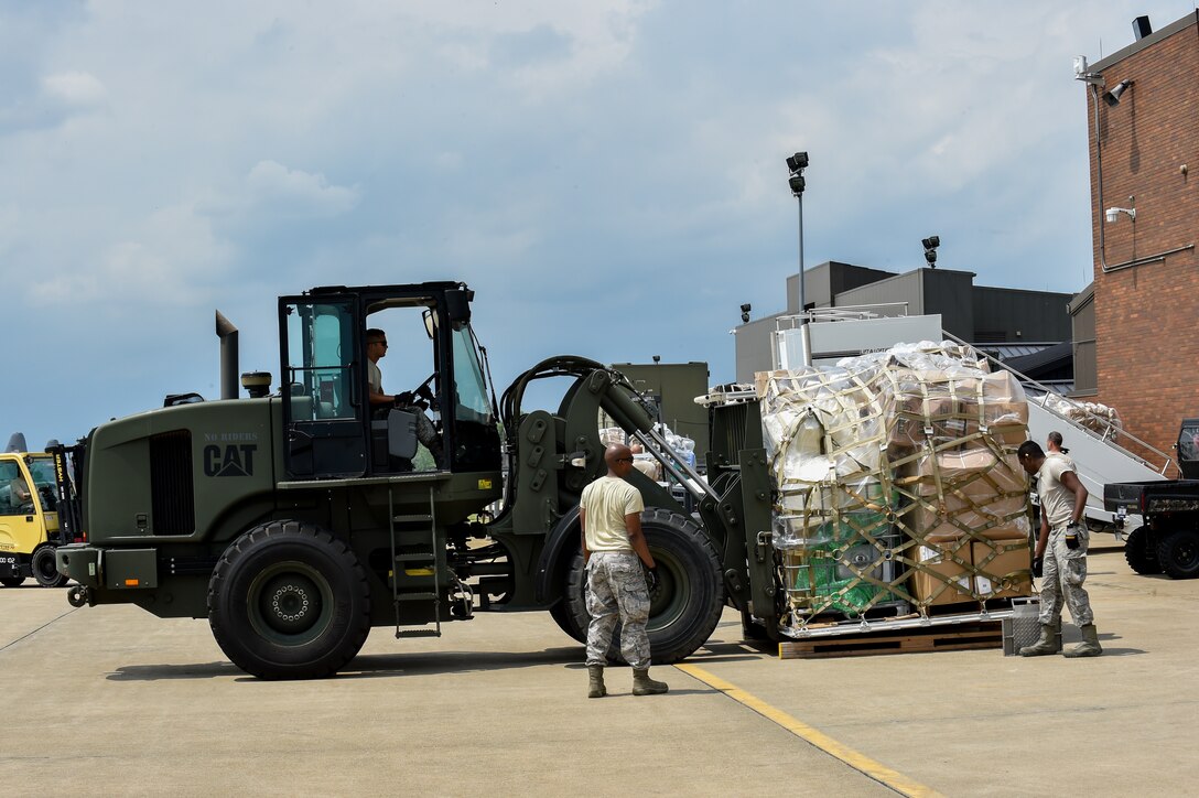 Staff Sgt. Christian Shipley operates an adverse terrain forklift while Staff Sgt. Donald Irby and Airman 1st Class Kevin Mills, all 76th Aerial Port Squadron (APS) aerial transporters, assist on the Youngstown Air Reserve Station flightline, June 3.