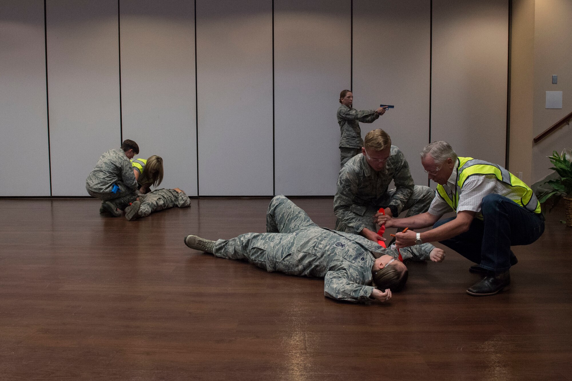 Members of the 97th Security Forces Squadron are assisted by instructors on how to provide medical support to victims while responding to an active shooter, during Advanced Law Enforcement Rapid Response Training, June 18, 2018, at Altus Air Force Base, Okla.