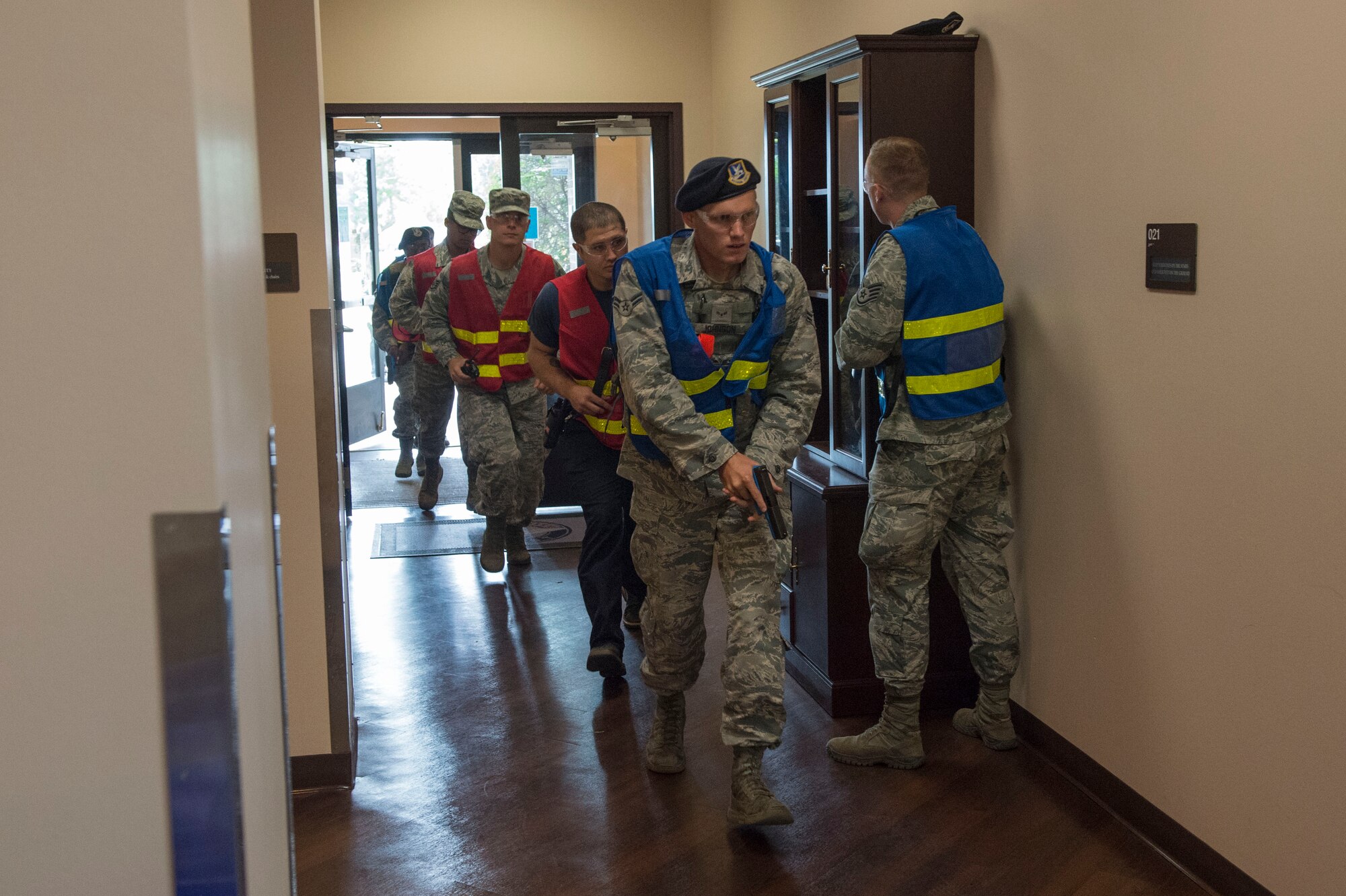Members of the 97th Security Forces Squadron escort Altus Air Force Base fire fighters to aid the victims of an active shooter, during Advanced Law Enforcement Rapid Response Training, June 19, 2018, at Altus AFB, Okla.