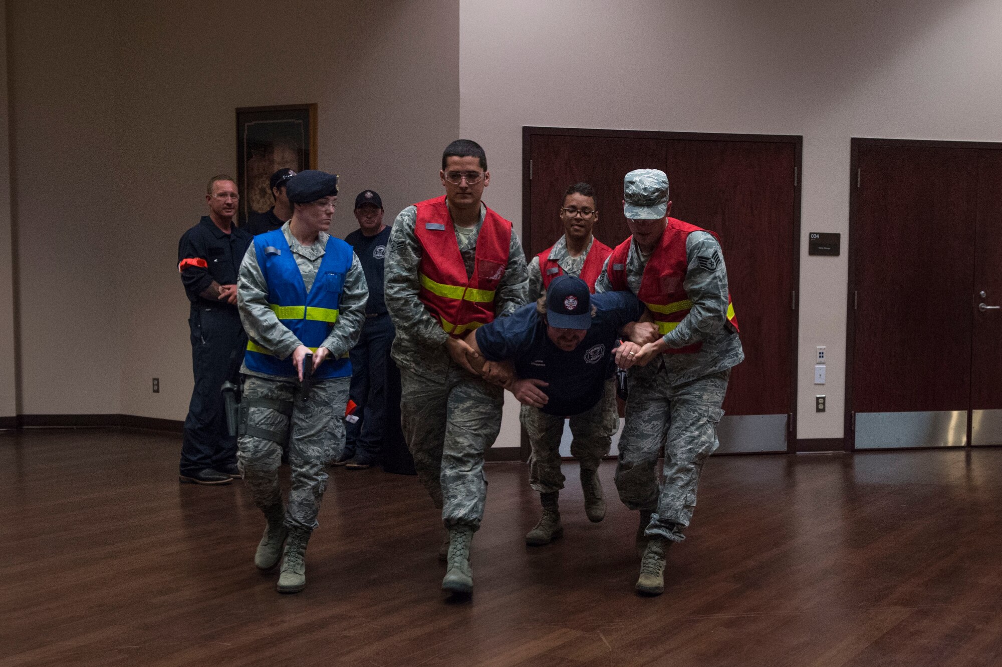 Altus Air Force Base fire fighters evacuate an injured victim, during Advanced Law Enforcement Rapid Response Training, June 19, 2018, at Altus AFB, Okla.