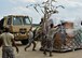 Staff Sgt. Donald Irby watches as Airman 1st Class Kevin Mills and Staff Sgt. Justin Knight, all 76th Aerial Port Squadron (APS) aerial transporters, toss a cargo net over a pallet of supplies on the Youngstown Air Reserve Station flightline, June 3.