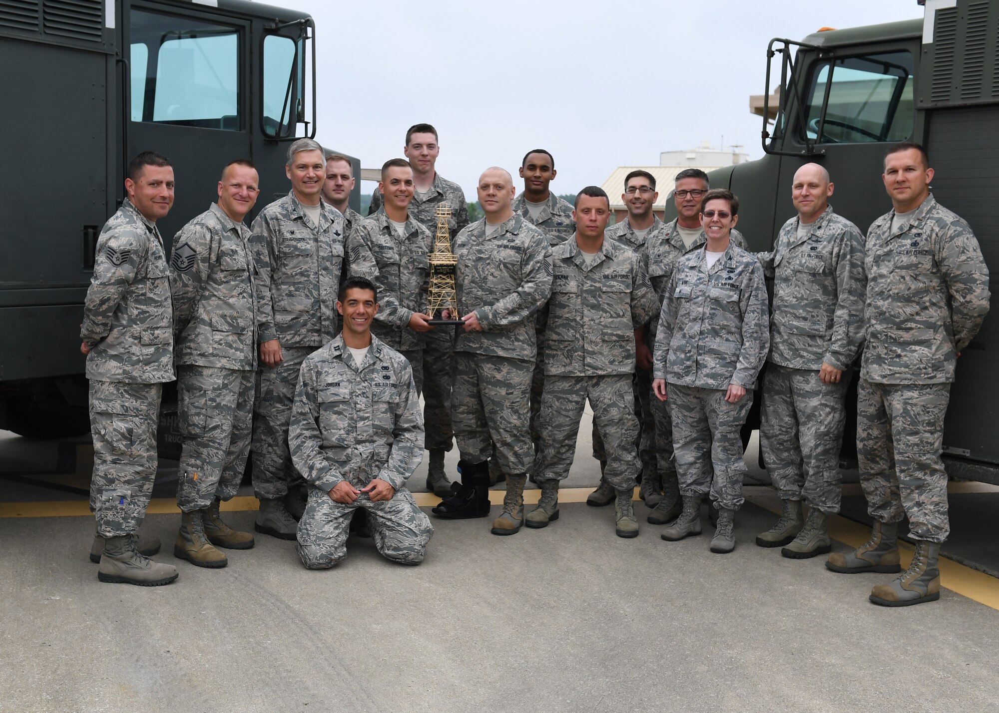 Col. Gretchen M. Wiltse and Col. Douglas Strawbridge stand with members of the 911th Fuels Management Flight on June 1, 2018, at Pittsburgh International Airport Air Reserve Station, Pennsylvania. The flight won the Golden Derrick award for Best Fuels Management Flight in the Air Force Reserve Command for 2017. Wiltse is the chief of the AFRC Logistics Readiness Division and Strawbride is the commander of the 911th Airlift Wing.(U.S. Air Force Photo by Staff Sgt. Zachary Vucic)