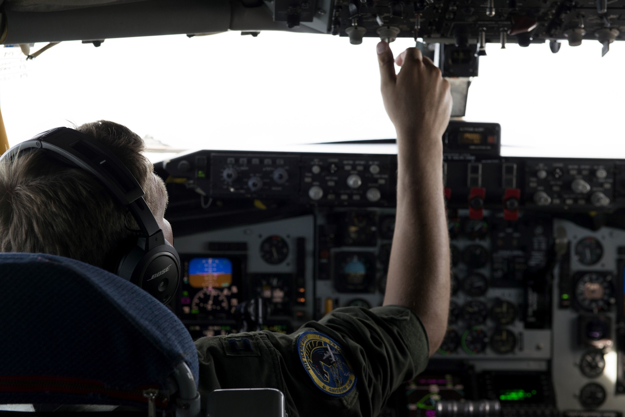 A U.S. Air Force pilot assigned to the 72nd Aircraft Refueling Squadron adjusts a dial on a KC-135R Stratotanker above the Atlantic Ocean, June 19, 2018.