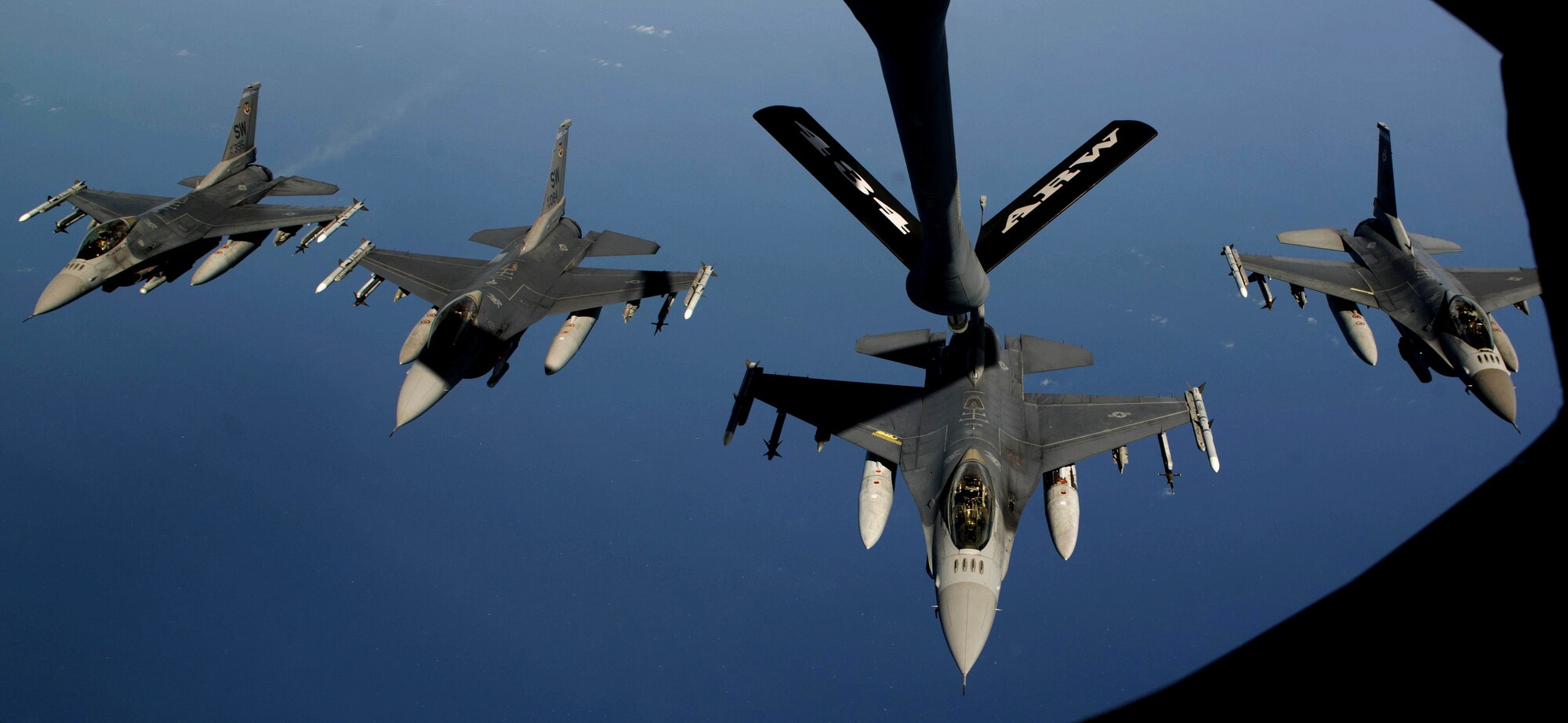 Four U.S. Air Force F-16CM Fighting Falcon pilots fly in formation above the Atlantic Ocean, June 19, 2018.