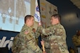 LTC Daniel Mitchell passes Charlotte Company Guidon to incoming Company Commander CPT Matthew King during the Change of Command Ceremony at Hendrick Motorsports Complex