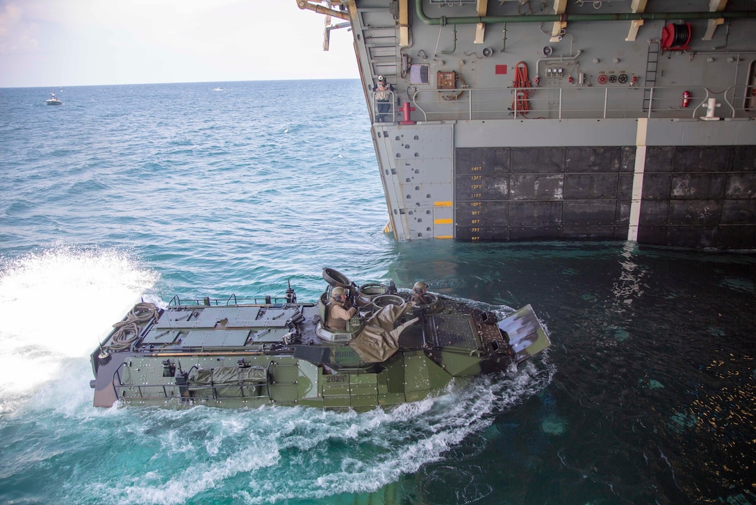 U.S. Marine AAV-P7/A1 Assault Amphibian Vehicles with the 22nd Marine Expeditionary Unit board the USS Arlington (LPD-24) via the well deck during Amphibious Squadron (PHIBRON)-MEU Integration training in the Atlantic Ocean, June 15, 2018. PHIBRON-MEU Integration is a two-week training evolution that allows Sailors and U.S. Marines to train as a cohesive unit in preparation for their upcoming deployment. (U.S. Marine Corps photo by Staff Sgt. Andrew Ochoa)