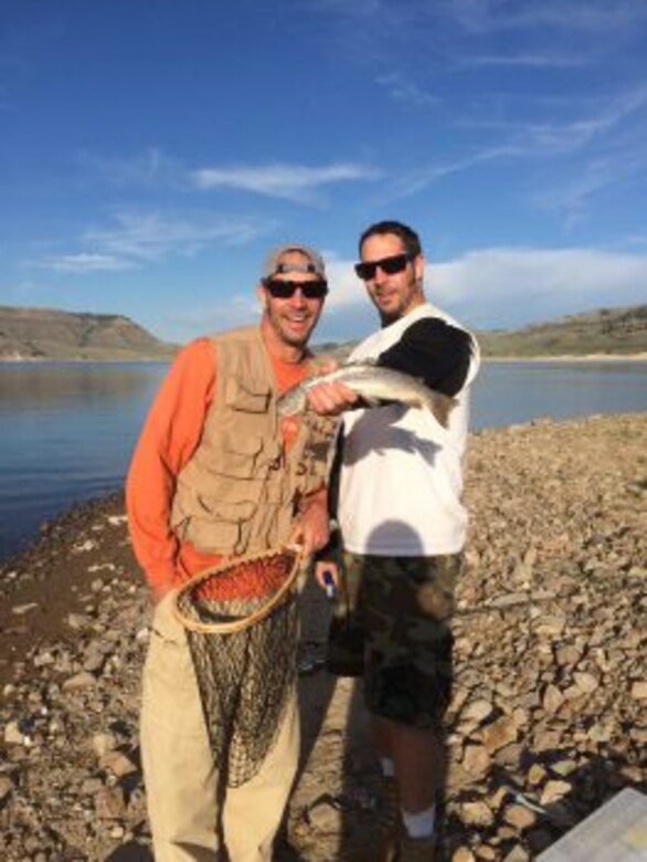 Justin (left) and Matt Scherzberg show off their catch during a fishing trip