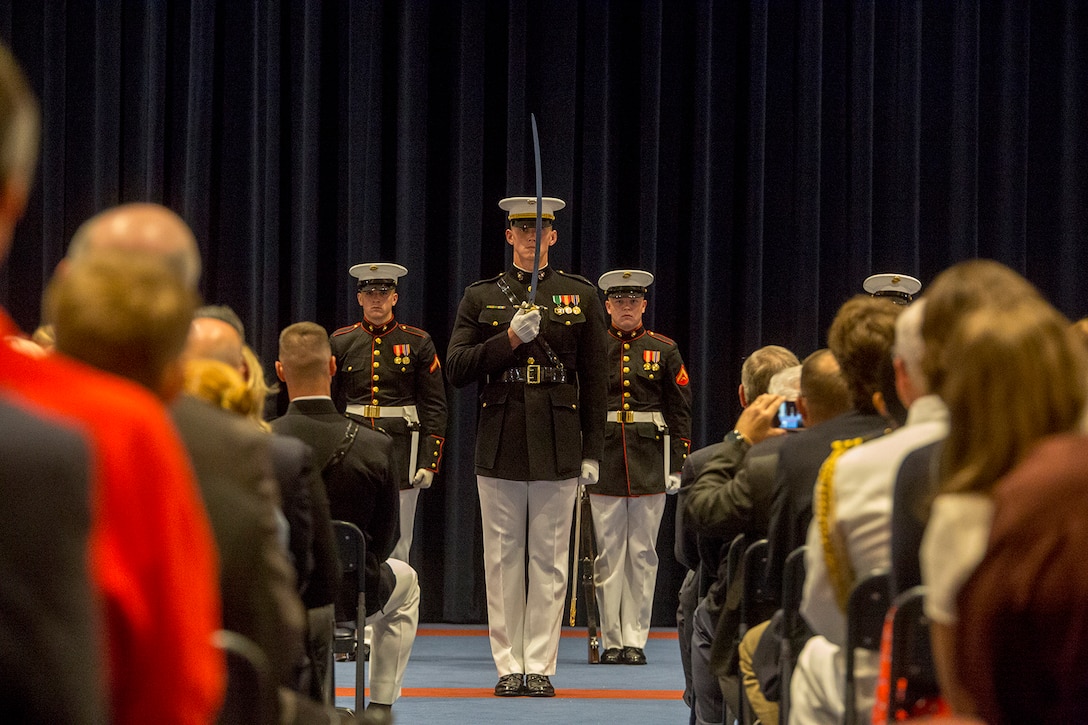Captain Matthew S. Galadyk, platoon commander, U.S. Marine Corps Silent Drill Platoon, renders a sword salute during a Friday Evening Indoor Ceremony at Marine Barracks Washington D.C., June 22, 2018. The guest of honor for the ceremony was Secretary of the Navy, Richard V. Spencer, and the hosting official was the Commandant of the Marine Corps, Gen. Robert B. Neller. (Official Marine Corps photo by Sgt. Robert Knapp/Released)