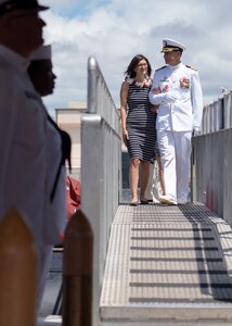 Capt. Robert A. Roncska (Ret.) and his family are piped ashore during the Submarine Squadron 7 change of command and retirement ceremony on the submarine piers in Joint Base Pearl Harbor-Hickam, June 22. (U.S. Navy photo by Mass Communication Specialist 2nd Class Michael H. Lee/Released)