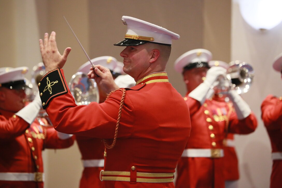 Captain James D. Foley, executive officer, “The Commandant’s Own” U.S. Marine Drum & Bugle Corps, conducts a musical ballad during a Friday Evening Parade at Marine Barracks Washington D.C., June 22, 2018. The guest of honor for the ceremony was the Secretary of the Navy, Richard V. Spencer, and the hosting official was the Commandant of the Marine Corps, Gen. Robert B. Neller.