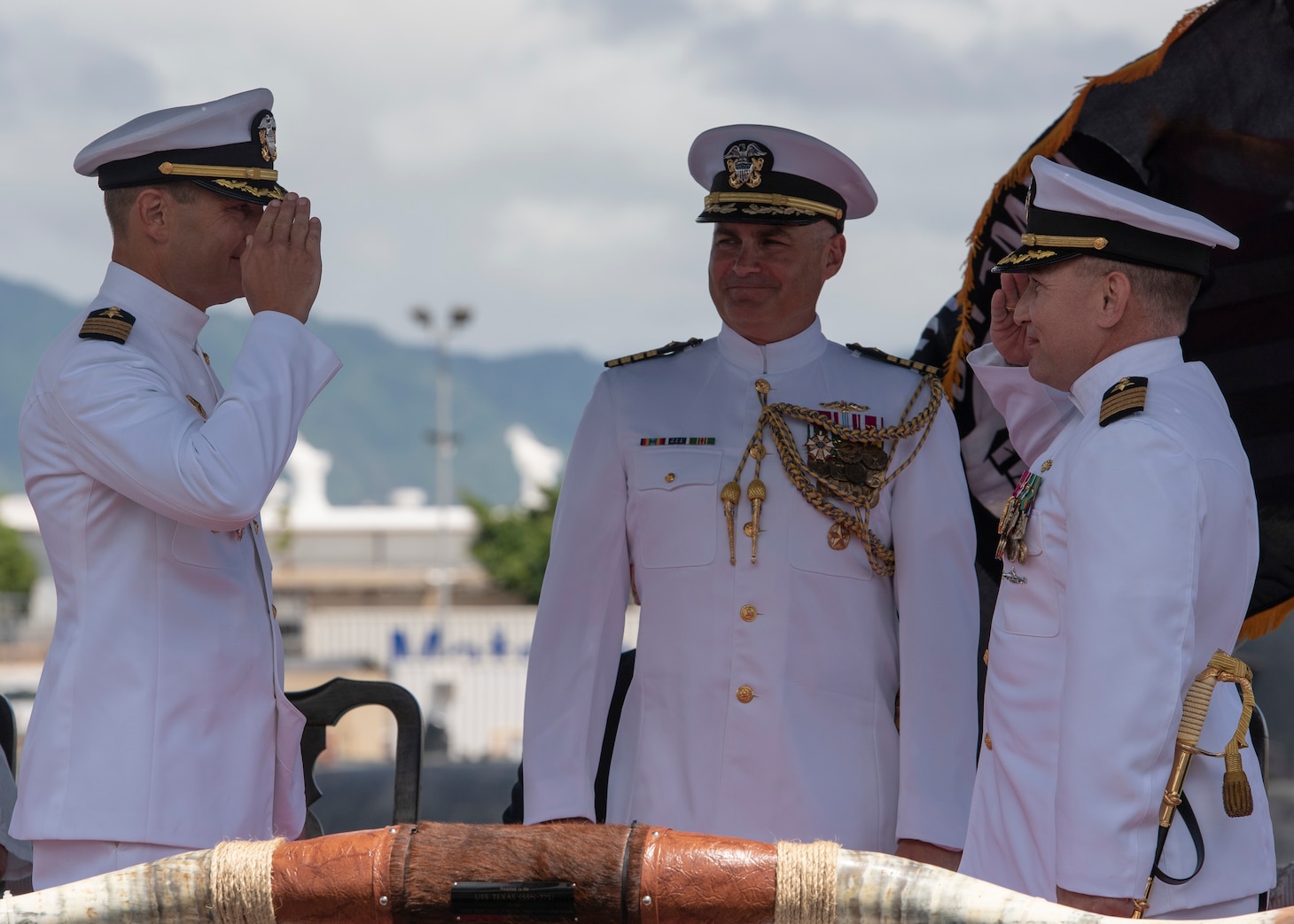 Capt. Paul Davis relieves Capt. Robert A. Roncska as commander of Submarine Squadron 7 during a change of command and retirement ceremony on the submarine piers in Joint Base Pearl Harbor-Hickam, June 22. (U.S. Navy photo by Mass Communication Specialist 2nd Class Michael H. Lee/Released)