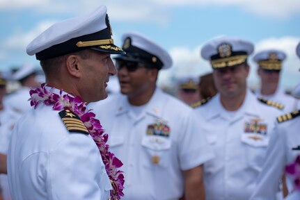 Guests, from the Submarine Squadron 7 change of command and retirement ceremony, bid farewell to Capt. Robert A. Roncska (Ret.) on the submarine piers in Joint Base Pearl Harbor-Hickam, June 22. (U.S. Navy photo by Mass Communication Specialist 2nd Class Michael H. Lee/Released)