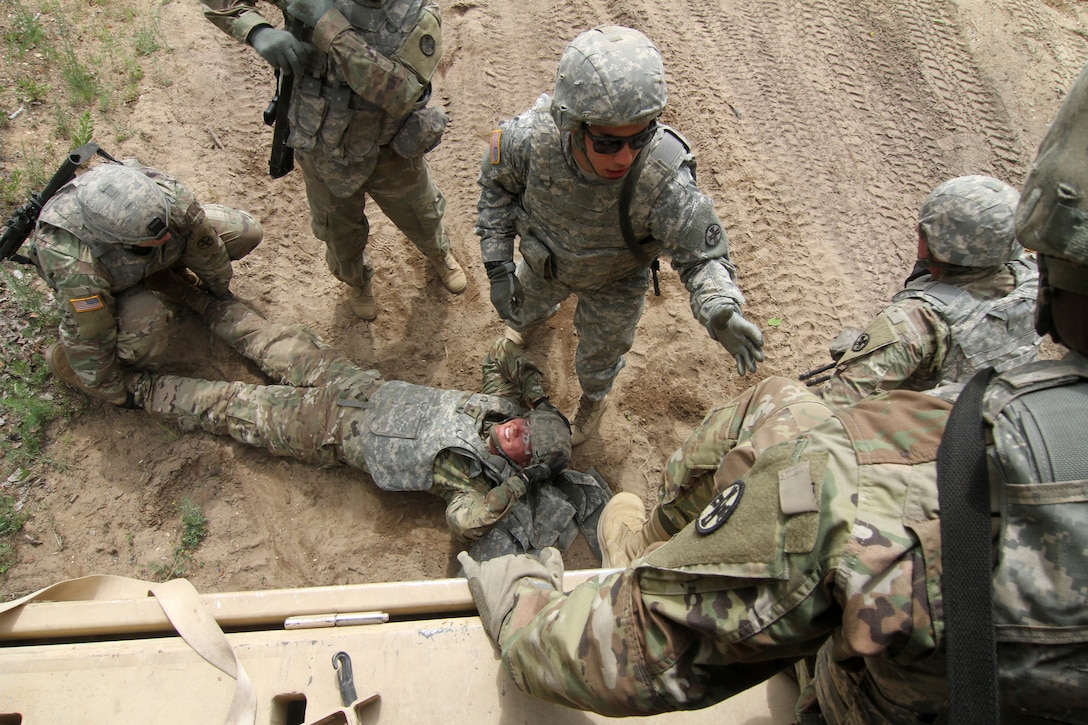 Soldiers prepare to evacuate a simulated casualty.