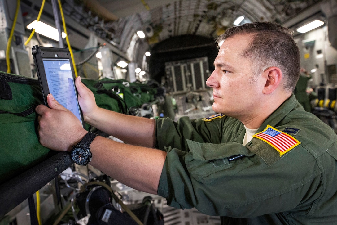 An airman performs a systems check on a vital signs monitor/defibrillator onboard a C-17 Globemaster III.