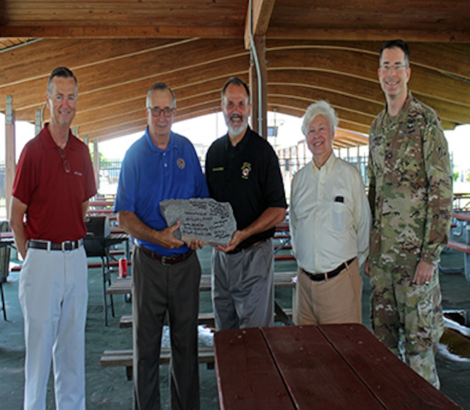 From left, Eddie Somers, president, Smith Island United; Randy Laird, president, Somerset County Commissioners; Mark Belton, Maryland Natural Resources secretary; Charles Halm, director, Community Planning and Development, U.S. Department of Housing and Urban Development, Baltimore Field Office; and Col. Ed Chamberlayne, commander, U.S. Army Corps of Engineers, Baltimore District, present a piece of jetty stone signed by the officials following a ceremony at Crisfield's Somers Cove Marina celebrating the completion of two jetties and a stone sill as part of a navigation improvement project at Rhodes Point on Smith Island, Maryland, June 21, 2018. The stone was placed at the Smith Island Cultural Center. (U.S. Army photo by Sarah Lazo)