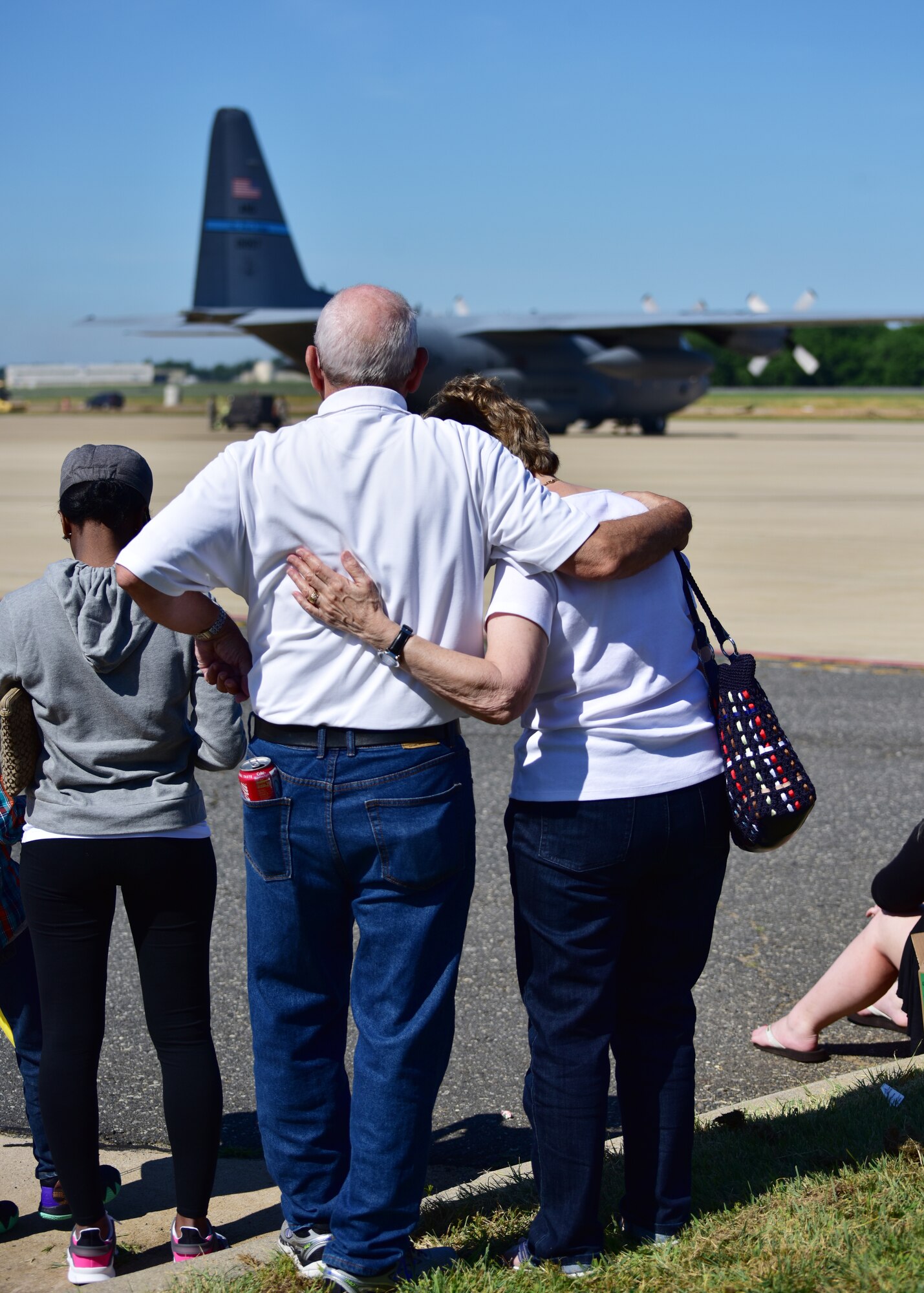 Families of Delaware Air National Guardsman watch as Airmen depart for deployment at New Castle Air National Guard Base, Del., June 25, 2018. Family members showed their support for deploying Airmen by attending a farewell event and watching as the aircraft departed from the flightline. (U.S. Air National Guard photo by Senior Airman Katherine Miller)