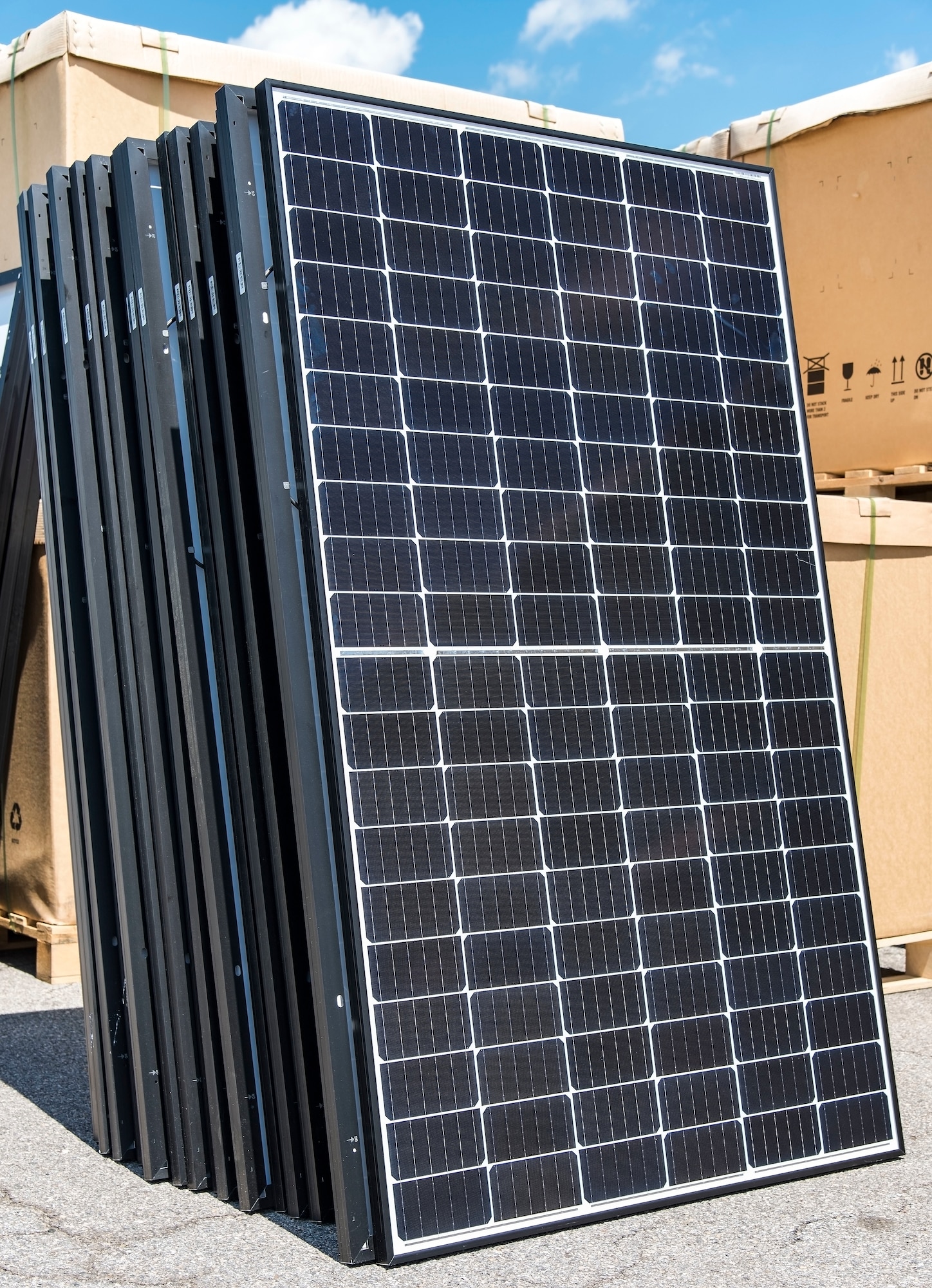 A group of unboxed photovoltaic (PV) panels wait to be taken to a job site in the Dover Family Housing community May 11, 2018, at the Base Theater on Dover Air Force Base, Del. One hundred forty-nine houses in the DFH community are scheduled to have the panels installed on them. (U.S. Air Force photo by Roland Balik)