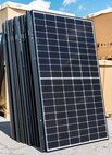 A group of unboxed photovoltaic (PV) panels wait to be taken to a job site in the Dover Family Housing community May 11, 2018, at the Base Theater on Dover Air Force Base, Del. One hundred forty-nine houses in the DFH community are scheduled to have the panels installed on them. (U.S. Air Force photo by Roland Balik)