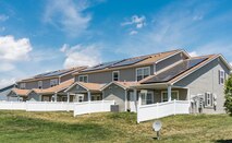 Photovoltaic (PV) panels installed on the back side of housing units in the Dover Family Housing community absorb sunlight to generate electricity May 11, 2018, at Dover Air Force Base, Del. Electricity generated by PV panels is transmitted to the electrical grid, not the individual housing units. Occupants will not see a reduction in their electricity bill. (U.S. Air Force photo by Roland Balik)