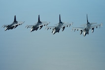 U.S. Air Force pilots assigned to the 77th Fighter Squadron navigate F-16 Fighting Falcons in formation over the Atlantic Ocean, June 20, 2018.