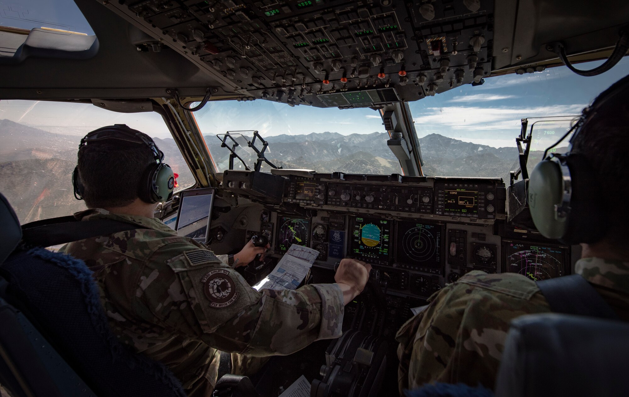 Maj. David Rodriguez, 732nd Airlift Squadron Instructor Pilot, and Capt. Ali Chinisaz, 6th Airlift Squadron instructor pilot, prepare to perform low-altitude, evasive maneuvers in a C-17 Globemaster III cargo aircraft over the Nevada Test and Training Range, June 9, 2018. The C-17 is capable of performing rapid strategic delivery of troops and all types of cargo. (U.S. Air Force photo by Airman 1st Class Andrew D. Sarver)