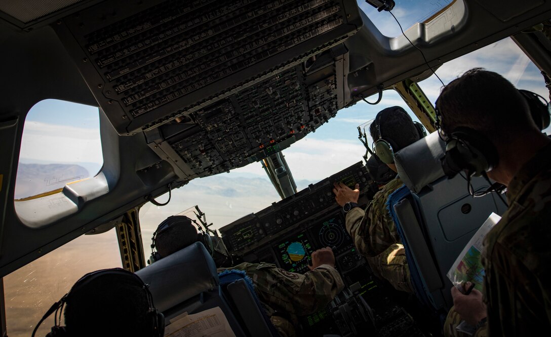 C-17 Globemaster III cargo aircraft pilots perform low-altitude, evasive maneuvers during a training exercise over the Nevada Test and Training Range, June 9, 2018. The pilots performed the exercise to simulate a joint forcible entry exercise. (U.S. Air Force photo by Airman 1st Class Andrew D. Sarver)