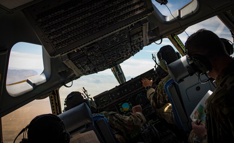 C-17 Globemaster III cargo aircraft pilots perform low-altitude, evasive maneuvers during a training exercise over the Nevada Test and Training Range, June 9, 2018. The pilots performed the exercise to simulate a joint forcible entry exercise. (U.S. Air Force photo by Airman 1st Class Andrew D. Sarver)