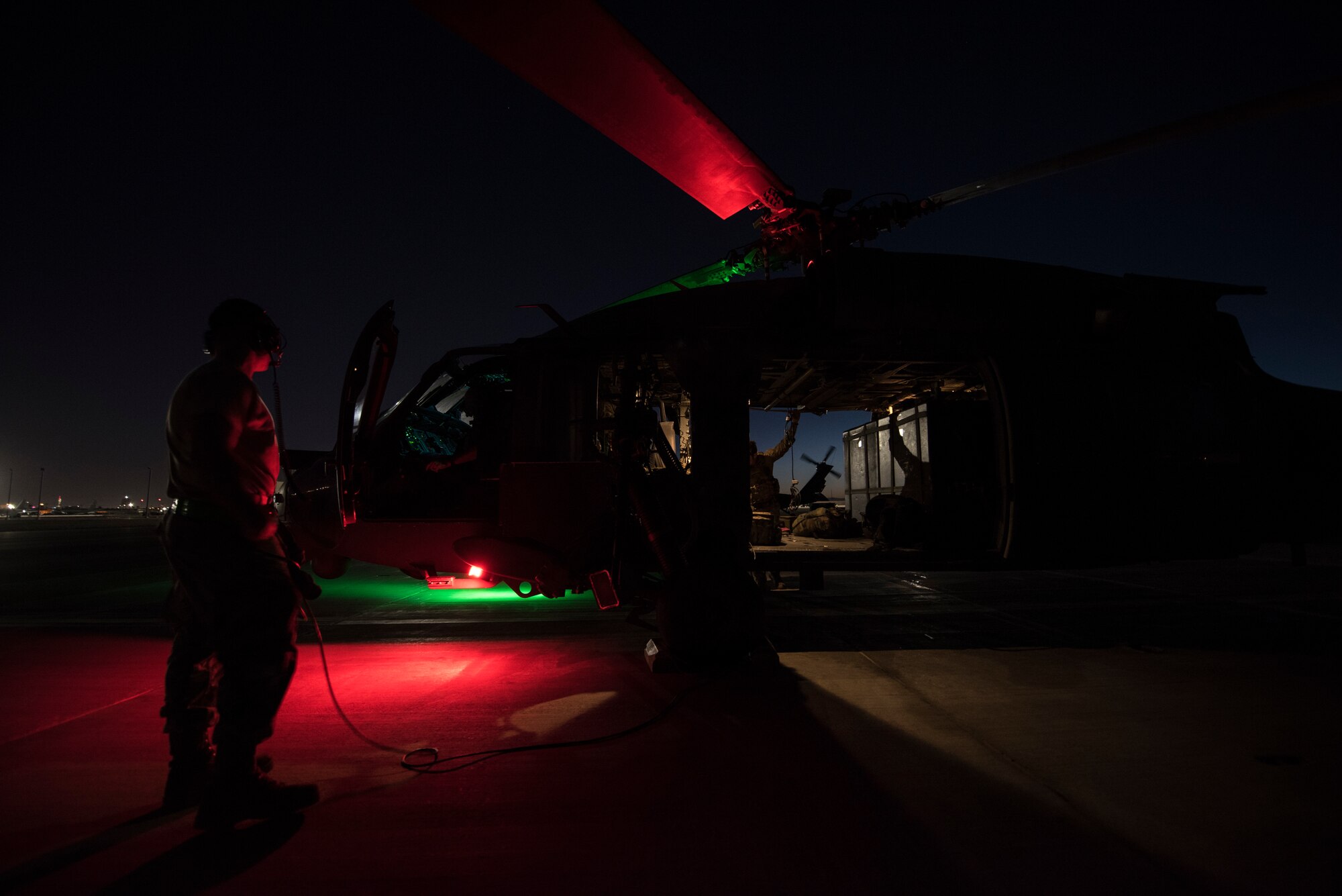 A crew prepares an HH-60G Pave Hawk helicopter prior to a large-scale U.S. Air Force Weapons School Integration Phase training exercise June 11, 2018 at Nellis Air Force Base, Nev. The scenario tested the Pave Hawk crew’s ability to work as part of a joint force in order to safely locate, recover, and treat a downed pilot in a contested environment. (U.S. Air Force photo by Staff Sgt. Joshua Kleinholz)