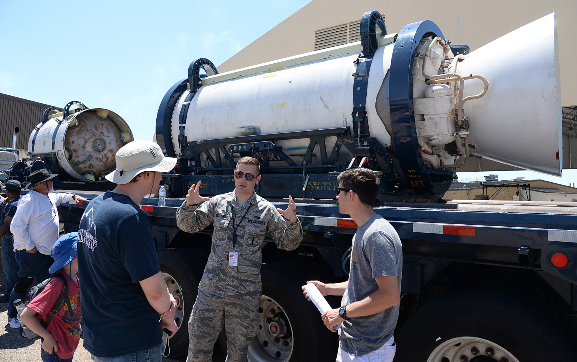 Staff Sgt. Cote Welliver, 581st Missile Maintenance Squadron, answers questions about Minuteman III Intercontinental Ballistic Missile solid fuel rocket motors during the Warriors Over the Wasatch Air and Space Show June 23, 2018, at Hill Air Force Base, Utah. The motors were part of the Ogden Air Logistics Complex's statics on display at the show. (U.S. Air Force photo by Alex R. Lloyd)