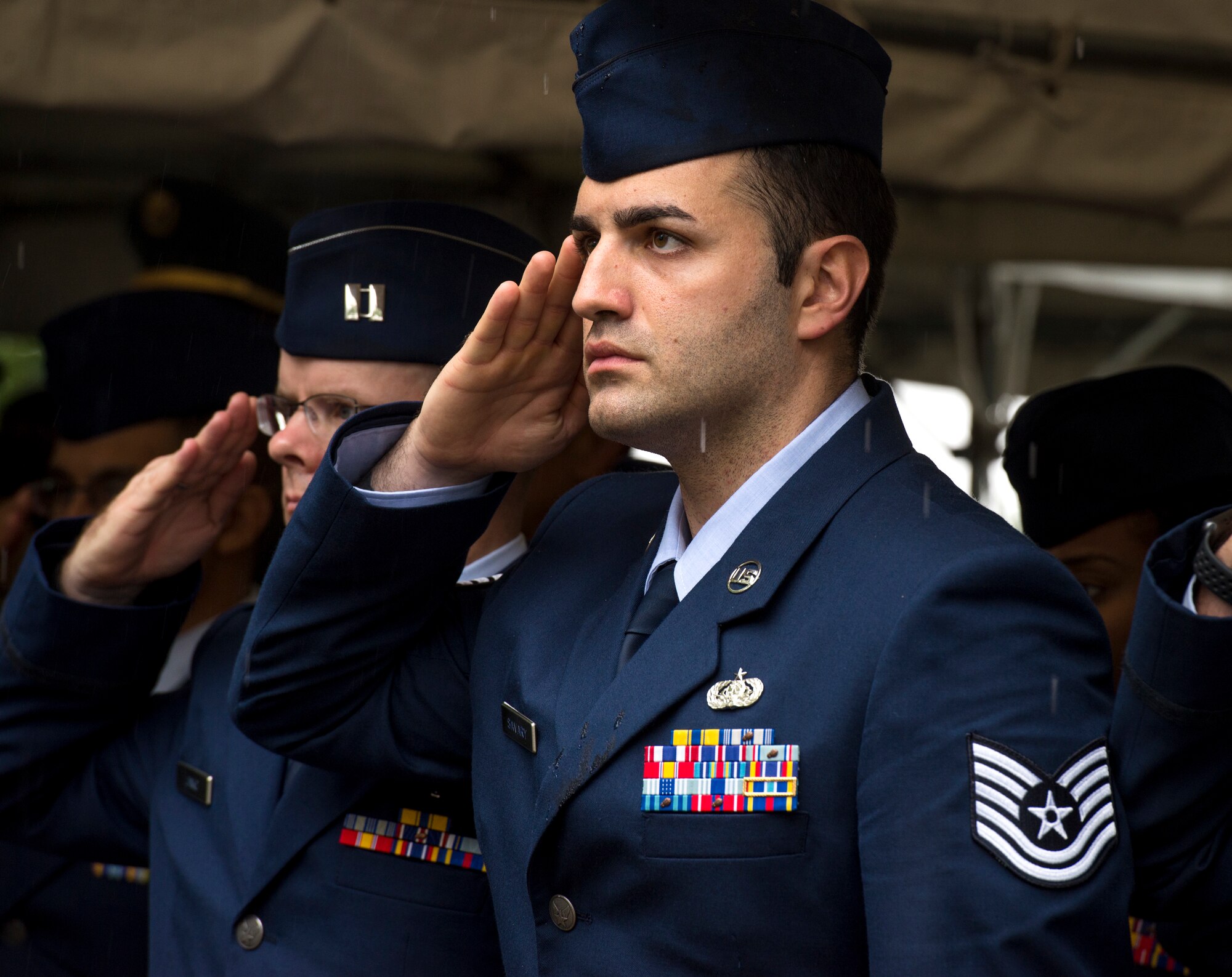 U.S. Air Force Tech. Sgt. Anthony Savary, 730 Air Mobility Squadron communications administrator, salutes during the playing of the National Anthem