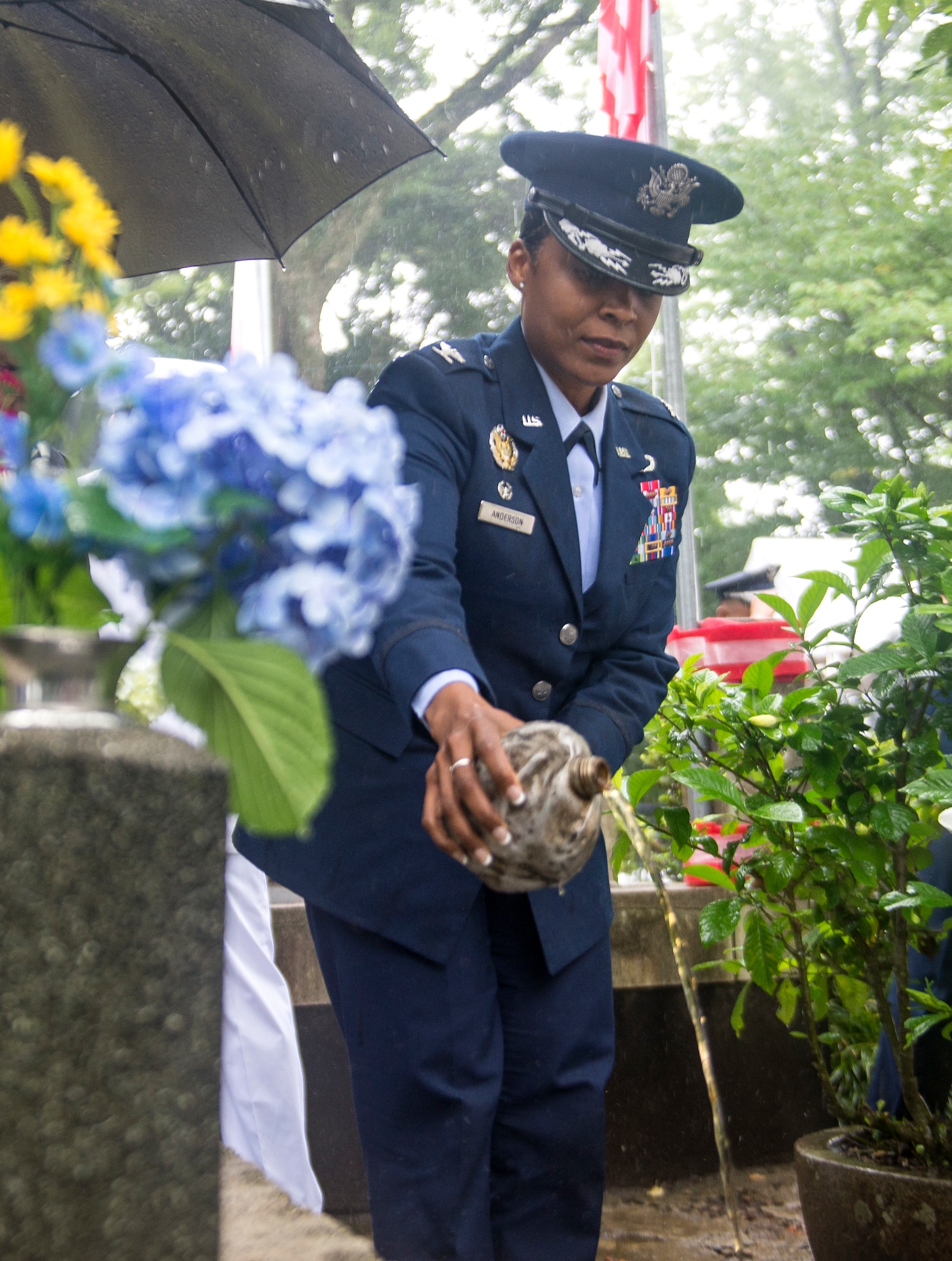 U.S. Air Force Col. Tanya J. Anderson, 374th Mission Support Group commander, pours whiskey on the B-29 memorial