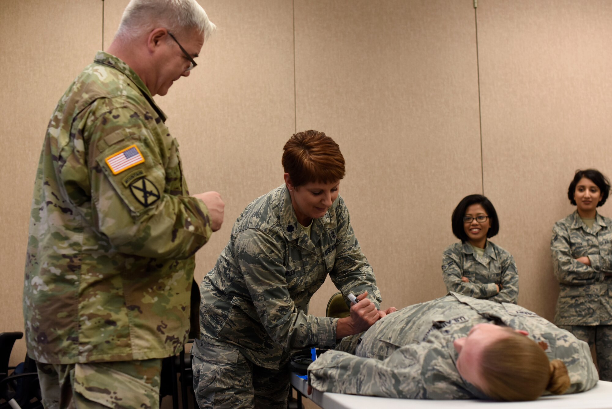U.S. Army Col. Wayne Thomas Frank, U.S. Army Medical Research Institute of Chemical Defense Casualty Care Division chief, observes U.S. Air Force Lt. Col. Suzanne Green, 92nd Medical Operation Squadron Family Health Flight commander, during a chemical agent casualty discussion at Fairchild Air Force Base, Washington, June 21, 2018. The two-day course trains professionals to be familiar and proficient in identifying the effects of biological and chemical attacks in order to understand how to medically manage casualties resulting from chemical or biological weapons. (U.S. Air Force photo/Airman 1st Class Jesenia Landaverde)