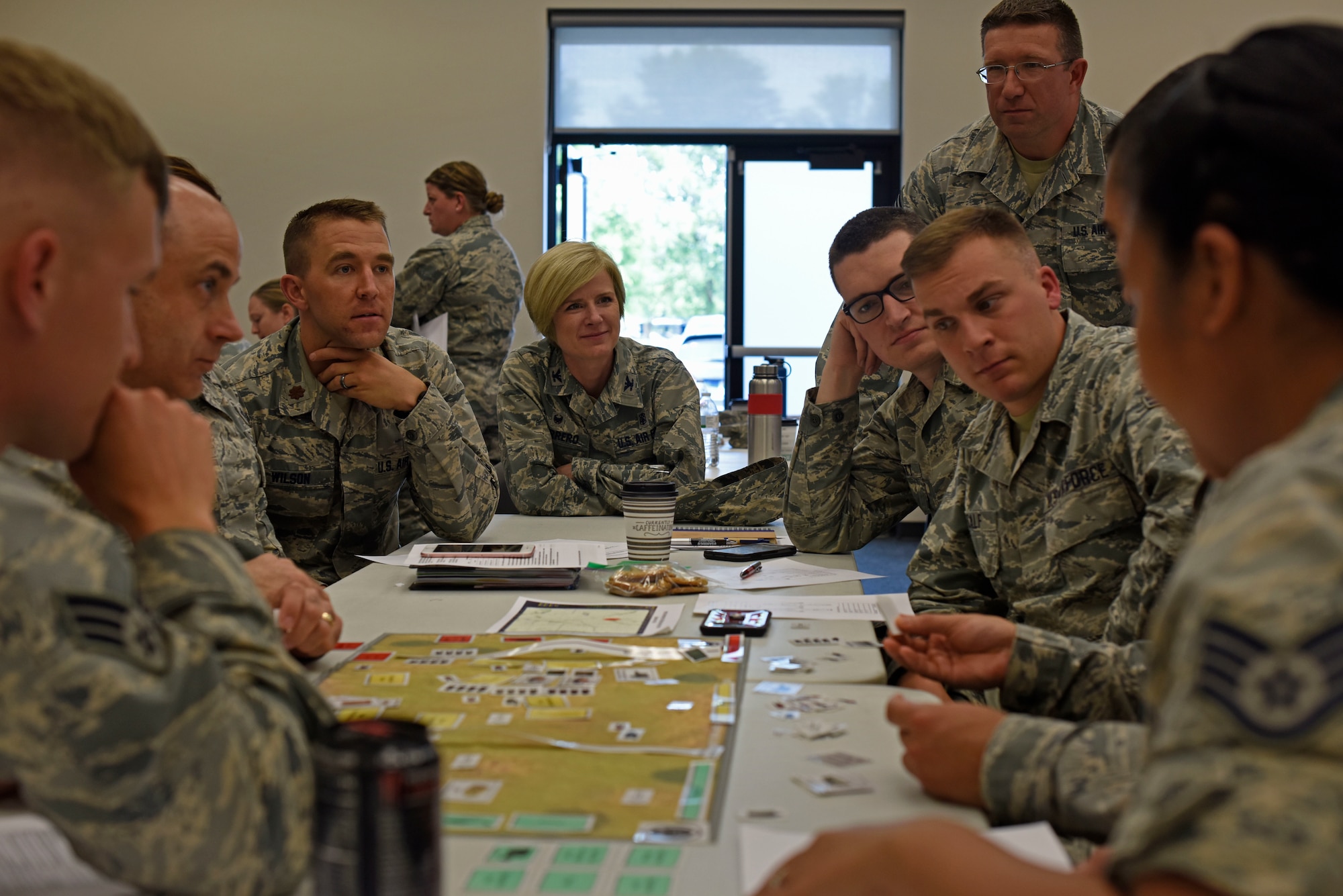 U.S. Air Force Col. Michelle Guerrero, 92nd Medical Group commander, interacts with Airmen while they set up a Patient Decontamination Site Tabletop Simulation Activity Kit  during the medical management section of the Chemical and Biological Casualties course at Fairchild Air Force Base, Washington, June 21, 2018. More than 80 Airmen from Team Fairchild participated in the course including Airmen from the 92nd Air Refueling Wing, 141st ARW, and 336th Training Squadron. (U.S. Air Force photo/Airman 1st Class Jesenia Landaverde)