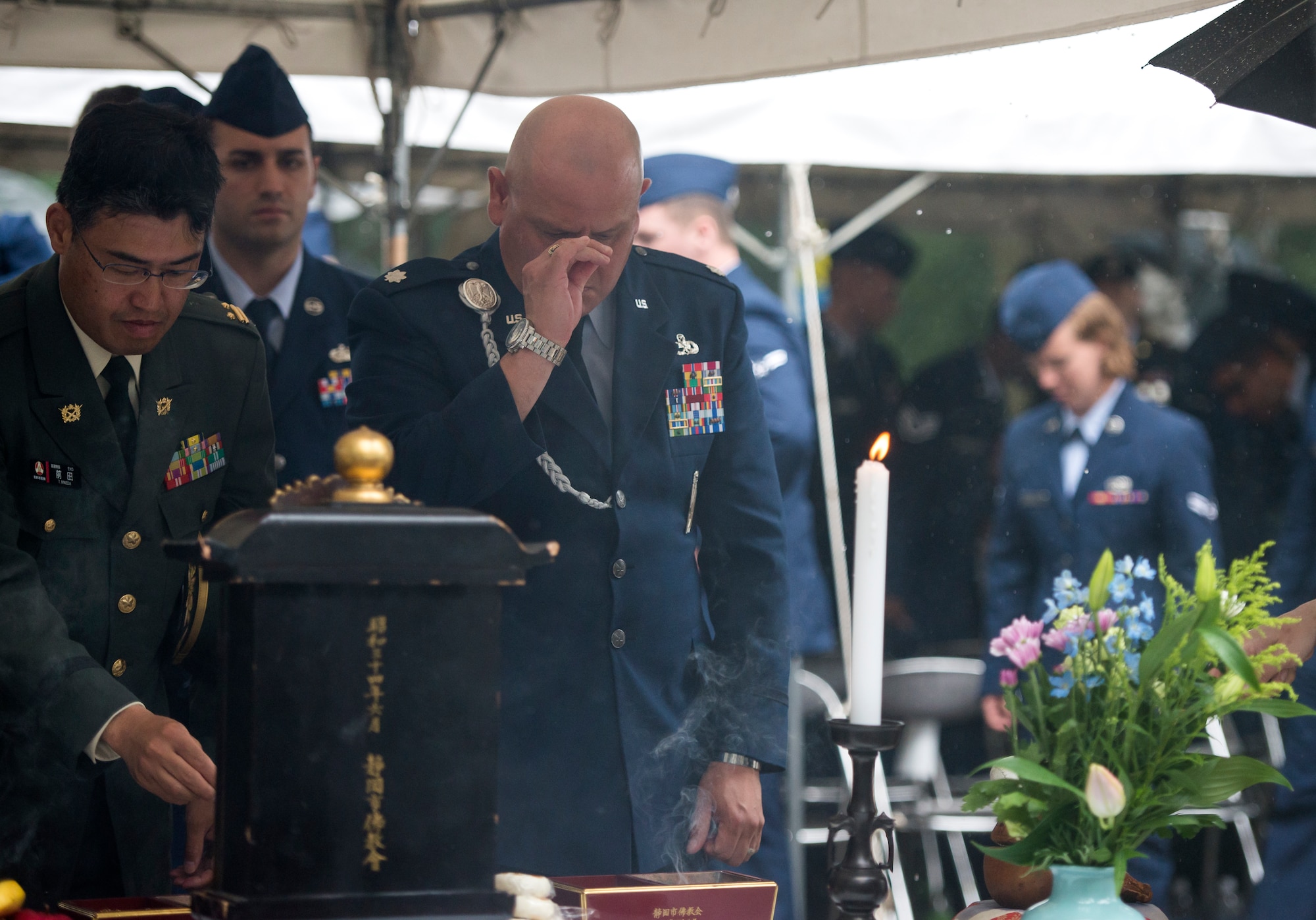 U.S. Air Force Lt. Col. William Villegas, 5th Air Force deputy director, participates in an incense ceremony